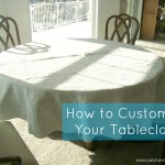 A round table covered with a white textured tablecloth is surrounded by wooden chairs in a sunlit room. Blue text reads, "How to Customize Your Tablecloth for any occasion.