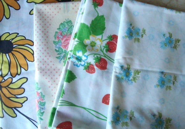 Can You Use Bed Sheets as Quilt Backing? What Quilters Should Know 2 four vintage sheets folded nicely and layered together on a table