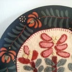 quilt blocks displayed in the center of a plate / patchworkposse.com