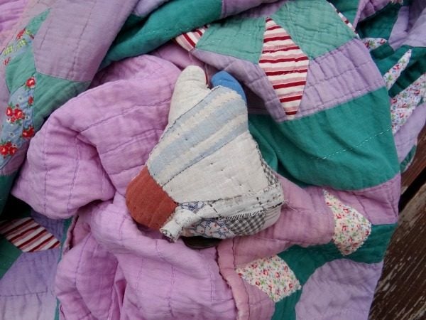 What to Do with Old Quilts: Creative Ways to Restore, Repurpose, and Display Vintage and Heirloom Quilts 6 Little toy guy with old quilt