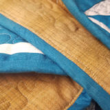 When it comes to binding your quilt, there is one little thing that I like to do to make the quilt just a little bit nice-- match the bobbin thread to the quilt backing fabric.