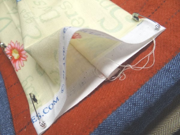 How to Make a Quilt Sleeve 10 showing how the quilt sleeve is placed on the back of the quilt