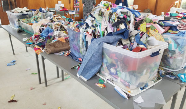 How to Make a Scrap Quilt 3 fabric scraps in bins on the table