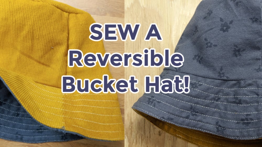 How to Sew a Bucket Hat and it's Reversible! 1 Image of two stylish reversible bucket hats—one side a chic mustard yellow, the other a patterned gray. Text overlay reads "SEW A Reversible Bucket Hat!" on a rustic wooden background.