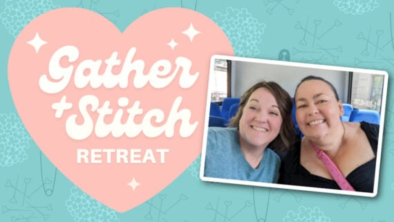 Two smiling people pose in a photo framed by a pink heart that reads "Gather + Stitch Retreat." The backdrop features a teal pattern adorned with small flowers and quilting pins.