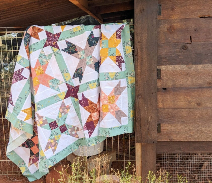 Free Eight Point Star Quilt Pattern 3 eight pointed star quilt hanging on a fence outside