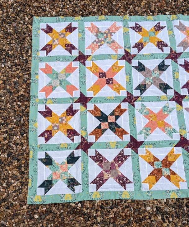 Free Eight Point Star Quilt Pattern 18 eight pointed star quilt laying on the gravel ground - it's a pattern