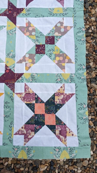 Free Eight Point Star Quilt Pattern 17 eight pointed star quilt laying on the gravel ground - it's a pattern
