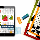 digital patchwork planner on an ipad screen next to thread and quilts on a table