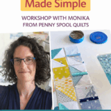 A smiling woman with curly hair and glasses stands by a workspace filled with colorful quilt fabric pieces. Text above advertises "Scrappy Fabric Pulls Made Simple"—learn to plan scrappy fabrics and pulls with Monika from Penny Spool Quilts.