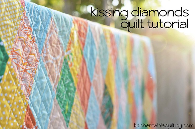 A colorful quilt with diamond patterns hangs outdoors, sunlight shining through the trees. Text reads "Kissing Diamonds Quilt Tutorial," perfect for fans of Diamond Quilt Patterns, and "kitchentablequilting.com" in the corner.
