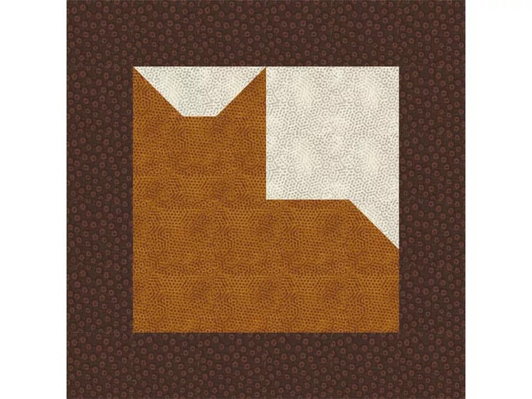 A cat quilt block featuring a geometric cat design in brown and white fabric, set against a dark brown patterned border. The stylized cat is created with sharp angles and simple shapes for a modern touch.