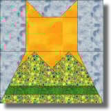 A cat quilt block depicting a stylized cat, with an orange head and ears, a multicolored patterned body, and a blue-gray background. The geometric fabric pieces create a charming addition to any cat quilt project.