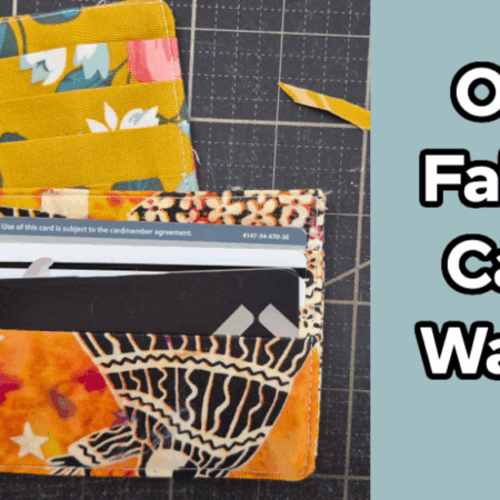 Two colorful fabric card wallets, one yellow with floral patterns and one orange with abstract designs, are displayed on a cutting mat. The text "One Fabric Card Wallet" appears on a blue background to the right, showcasing an easy to sew card wallet pattern.