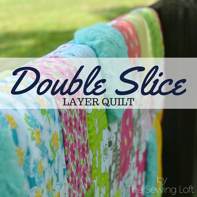 25 Baby Quilt Patterns So Cute You’ll Want to Start Sewing Today 24 A colorful patchwork baby quilt with various floral patterns hangs on a fence. Text overlay reads, "Double Slice Layer Quilt by The Sewing Loft.