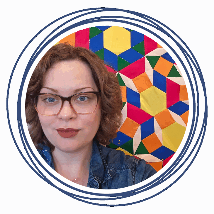 A woman with wavy light brown hair, glasses, and a denim jacket smiles slightly in front of a colorful geometric patterned background, evoking the artistry of a quilting summit. Circular blue lines frame the image.