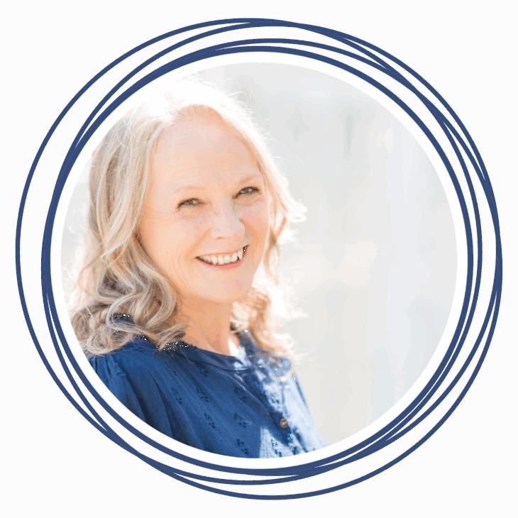 Smiling older woman with wavy gray hair, wearing a navy blue top, pictured inside a circular navy border on a light background. Perfect for promoting events like Move the Needle or sharing expertise in machine quilting.