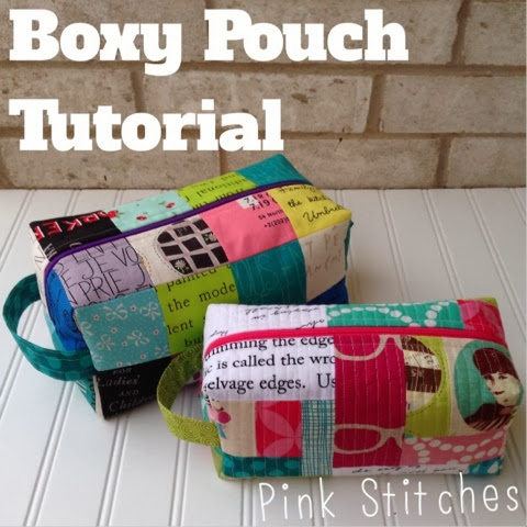 Quilt-As-You-Go Bag and Pouch Patterns You'll Want to Make 7 Two colorful, rectangular patchwork fabric pouches with side handles are displayed on a white surface. Text reads "Boxy Pouch Tutorial" at the top and "Pink Stitches" at the bottom, showcasing easy pouch patterns for all skill levels.