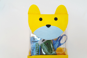Easy and Cute Lunch Bag Sewing Patterns You'll Want to Make and Use 3 A yellow and blue animal-themed pouch with a clear front contains art supplies, including a paint tube, scissors, and a glue stick—making it perfect inspiration for easy sewing patterns or even cute lunch bags.