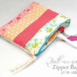 A colorful, quilted zipper bag with floral and striped bag patterns is unzipped, showing scissors and sewing tools inside. The bag rests on a white surface with "Quilt-As-You-Go Zipper Bag" text beside it.